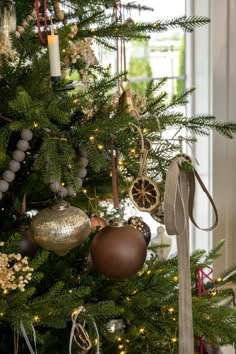 a christmas tree with ornaments hanging from it