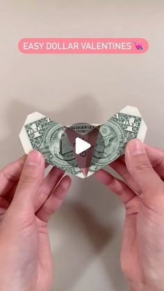 two hands holding money with the words easy dollar valentines written on it and an origami heart