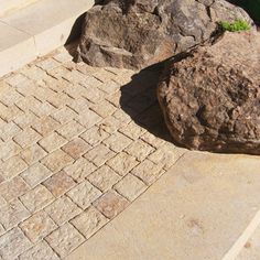 a red fire hydrant sitting next to two large rocks