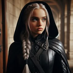 a woman with long blonde hair wearing a black leather outfit and braid in front of a doorway