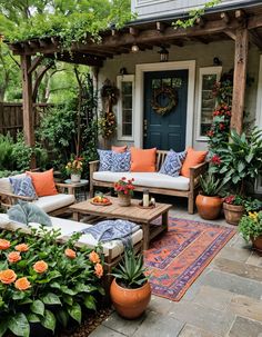 an outdoor living area with couches and potted plants