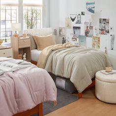 a bed room with a neatly made bed and lots of pictures hanging on the wall