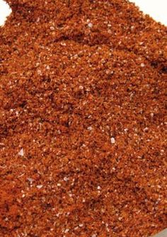 a pile of ground spices on a white surface