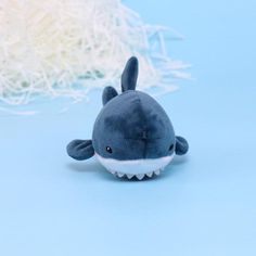 a small stuffed animal shark on a blue background