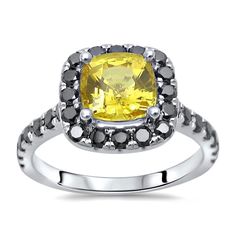 a yellow and black diamond ring with white diamonds on the sides, set in sterling