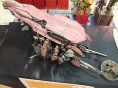 a pink sci - fi vehicle is on display