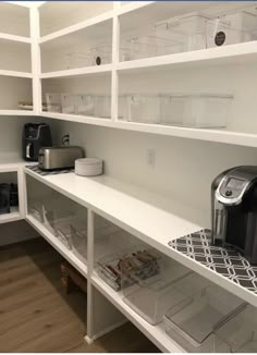 an organized pantry with coffee maker, toaster, and other items on the shelves