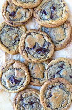 chocolate chip cookies are arranged on wax paper