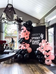 balloons are arranged in the shape of bats on display at a halloween themed birthday party