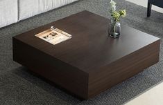 a coffee table sitting on top of a carpeted floor