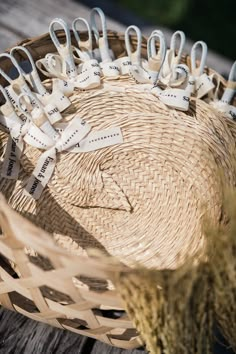 a basket filled with scissors sitting on top of a wooden table