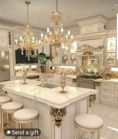 a large kitchen with white cabinets and chandelier hanging from the ceiling, along with four stools