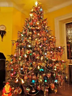 a brightly lit christmas tree in a living room