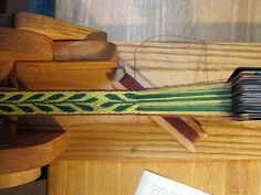 a close up of a wooden object on top of a table next to a book