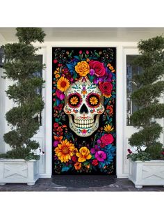 a door decorated with colorful flowers and a sugar skull on it's front porch