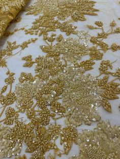 This high quality Fabric is measured in 5 Yards With Embroidered Beading and Sequin. It is soft, very delicate and beautiful. This high Quality Fabric is made with Fashion embroidered rhinestones can be used in making party wedding dresses, skirts, shawls, scarves and other other fashion apparels as you would like. Size : Length : 5 yards (180 inch). Width: 50 inch (Please allow slight deviation for the measurement data ,±1 inch) Material: 100% Polyester, Tulle Lace Fabric, Eco-Friendly embroide Luxury Sequin Fabric For Party Season, Luxury Gold Sequin Fabric With Intricate Embroidery, Luxury Gold Beaded Embroidered Fabric, Gold Embroidered Fabric With Pearl For Wedding, Elegant Gold Embroidered Fabric With Pearl Details, Gold Embellished Embroidered Fabric For Ceremony, Gold Pearl Embroidered Fabric For Reception, Gold Beaded Sequin Fabric For Wedding, Gold Sequin Fabric With Pearl Embroidery For Wedding