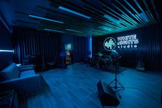 a recording studio with blue lighting and sound equipment