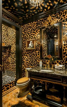 a bathroom with leopard print on the walls and a toilet in front of a mirror