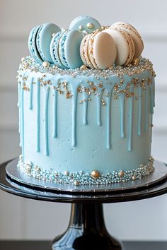 a blue cake with icing and macaroons on top