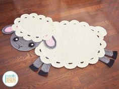 two sheep rugs sitting on top of a wooden floor