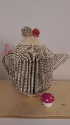 an origami teapot and cupcake on a table