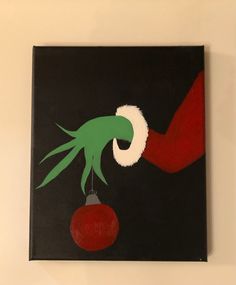 a painting on a wall with an ornament hanging from it's side