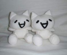 two white stuffed animals sitting next to each other on top of a bed covered in white sheets