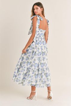 Channel sunny-day vibes in this romantic midi sundress topped by flirty shoulder ties and styled with a sultry ruched bust. • Chiffon floral print • Ruched bust • Light bra-cup • Tiered midi dress• Self tie shoulder straps• Back smocked • Back Zipper detail Cindy Dress, Bedroom Girl, Flower Maxi Dress, Floral Bustier, Blue Florals, Bra Cup, Tiered Midi Dress, Flowing Skirt, Dresses By Length