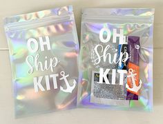 two holographic bags with the words oh ship ships kit and an anchor on them