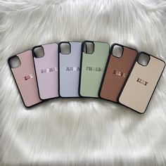 four iphone cases sitting on top of white fur