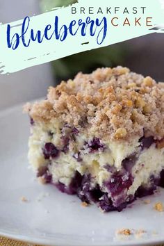 a piece of blueberry crumb cake on a white plate with the words, breakfast blueberry cake