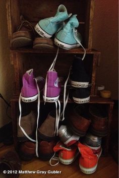 there are many pairs of shoes that are on the shelf next to eachother