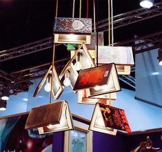 a chandelier made out of books hanging from the ceiling