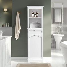 a bathroom with green walls and white fixtures