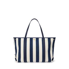 Crafted from woven herringbone twill yarn-dyed with the season’s striped pattern Lauren Ralph Lauren’s large Emerie tote is designed with a spacious convertible silhouette perfect for storing your essentials. The ultimate bag for every occasion whether it’s a weekend getaway or running errands it’s designed with pebbled leather straps and a nautical-inspired “LRL Lauren Ralph Lauren” logo patch at the front. Navy Tote Shoulder Bag For Vacation, Ralph Lauren Tote Shoulder Bag For Errands, Summer Nautical Style Tote Bag, Nautical Tote Bag For Vacation, Blue Nautical Travel Bag, Nautical Sail-colored Beach Bag, Ralph Lauren Logo, Weekend Getaway, Lauren Ralph Lauren