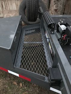 a flatbed trailer with a tire on the back and an extension to the side