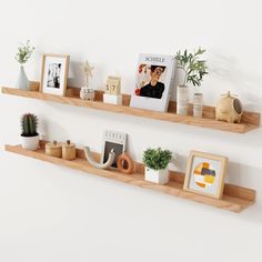 two wooden shelves with pictures and plants on them