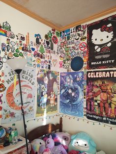 a bedroom with posters on the wall and stuffed animals all over the room, as well as a lamp