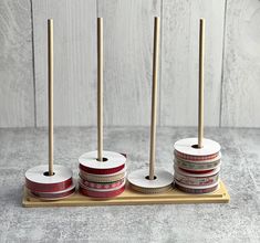 four rolls of toilet paper sitting on top of a wooden holder with two toothbrushes