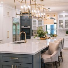 a large kitchen with an island and chairs