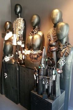 there are many mannequins on display in this room, all wearing different jewelry