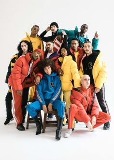 a group of people posing for a photo with one person wearing an orange and blue outfit