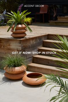 two planters sitting on top of wooden steps