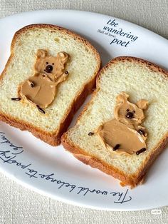 two pieces of bread with peanut butter and a teddy bear on it, sitting on a plate