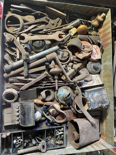 an old box filled with lots of tools like wrenches, pliers and screwdrivers