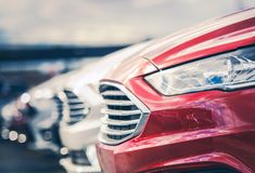 a row of red and white cars parked next to each other