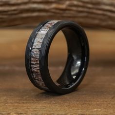 THE BIGHORN is THE bad boy of the group. A little dark and mysterious yet incredibly handsome. The black hammered tungsten gives this ring an undeniably “cool” feel. It’s tough and truly unique, thanks to its rugged features. This design was made by demand, and since it's release, it has definitely been one of our most popular designs! ABOUT THIS RING Material: Tungsten Carbide and Antler Color/Finish: Black/Hammered Edge Polished Width: Men's Standard 8mm *All Antler Rings are 100% Unique so co Antler Engagement Ring, Deer Antler Wedding Band, Antler Rings, Whiskey Barrel Wedding, Antler Wedding Rings, Antler Wedding Band, Deer Antler Ring, Western Rings, Antler Wedding