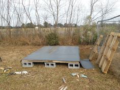 an outdoor area with several pieces of wood and cinder blocks