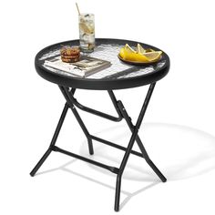 a black table with a drink and some food on it