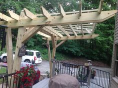 a covered patio area with an umbrella and grill